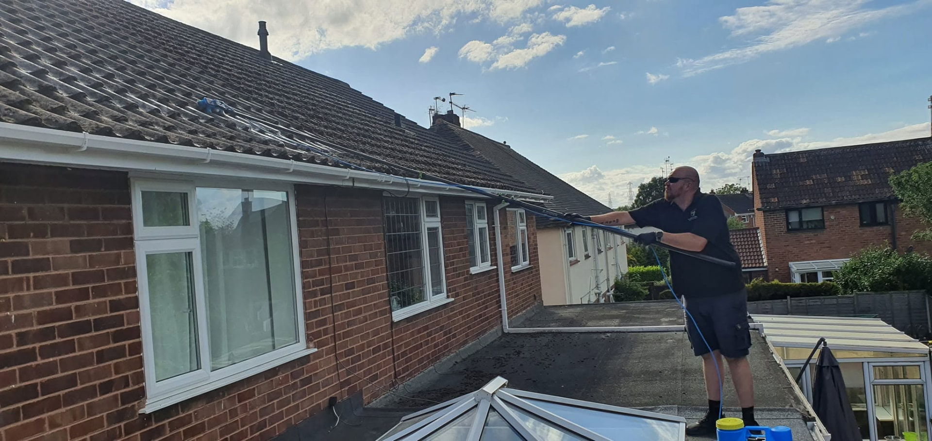 Soft wash roof cleaning in progress on a tiled roof in Redditch, Worcestershire