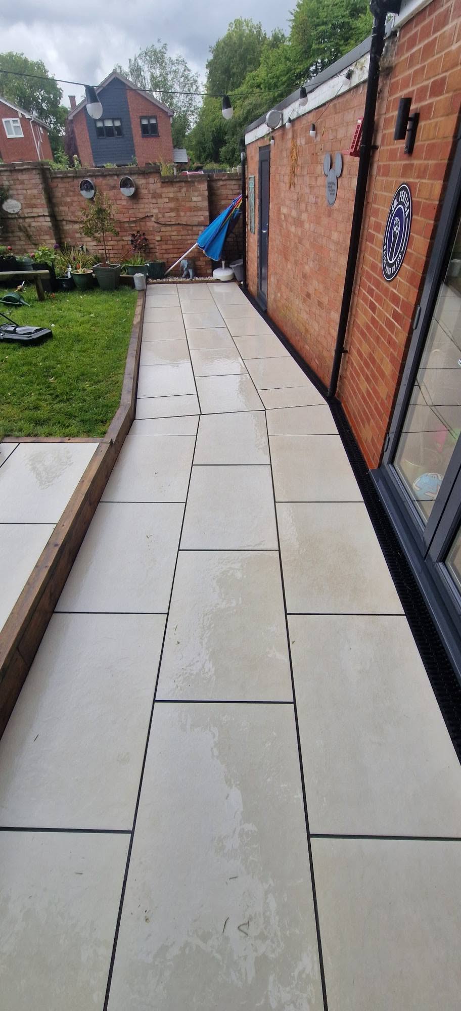 The same porcelain patio walkway cleaned to an even pale finish