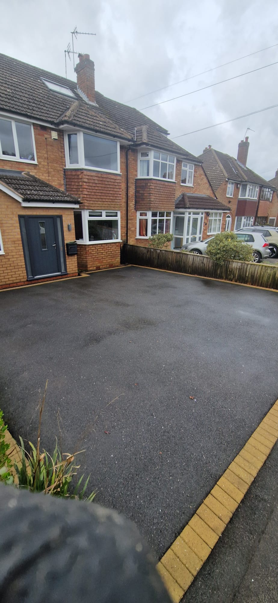 Clean tarmac driveway outside a semi detached house after pressure washing in Redditch, Worcestershire